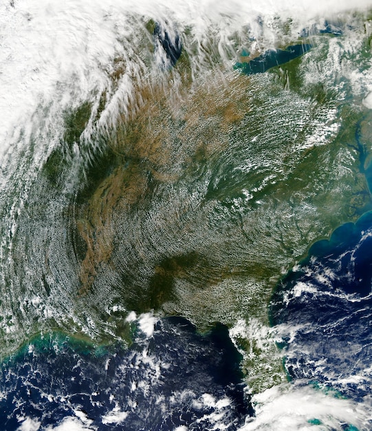 A satellite view of Earth showing areas affected by climate change, such as rising sea levels and intense storms, emphasizing the global nature of the issue.