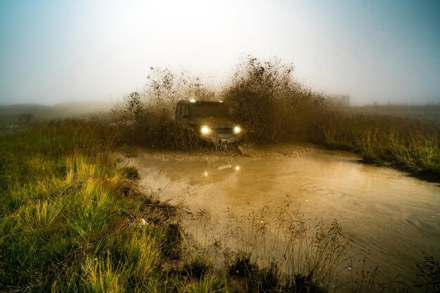 Farmers in a flooded field attempting to salvage crops, with dark storm clouds overhead and submerged agricultural machinery, illustrating the impact of extreme rainfall.