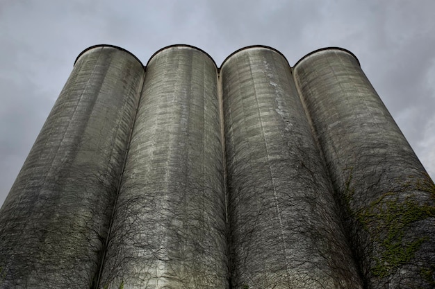Industrial facility with carbon capture units attached to smokestacks, showing pipelines transporting captured CO2 away towards underground storage sites. Dynamic perspective.