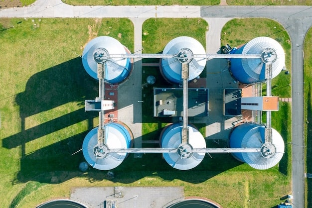 A large, modern water treatment plant with multiple filtration tanks and pipes under a clear blue sky, demonstrating advanced water infrastructure.