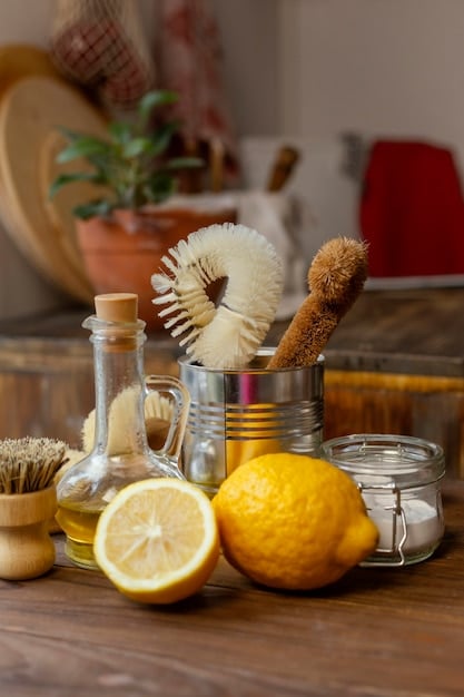 A variety of natural cleaning ingredients like baking soda, white vinegar, lemons, and essential oils neatly arranged on a wooden countertop with reusable spray bottles, emphasizing DIY solutions and cost savings.