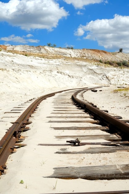A distorted and buckled railway track under a scorching sun, with heat haze rising from the ground.